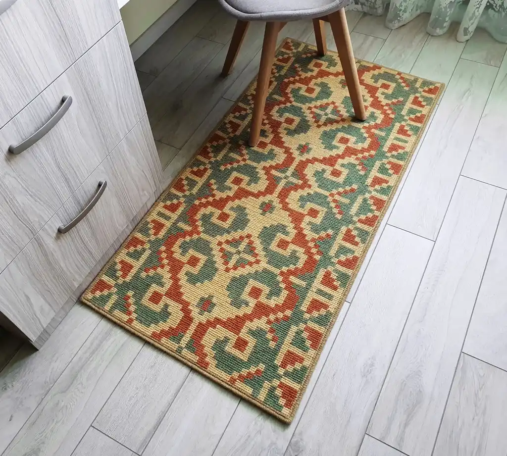 handcrafted wool rug with traditional embroidery pattern.