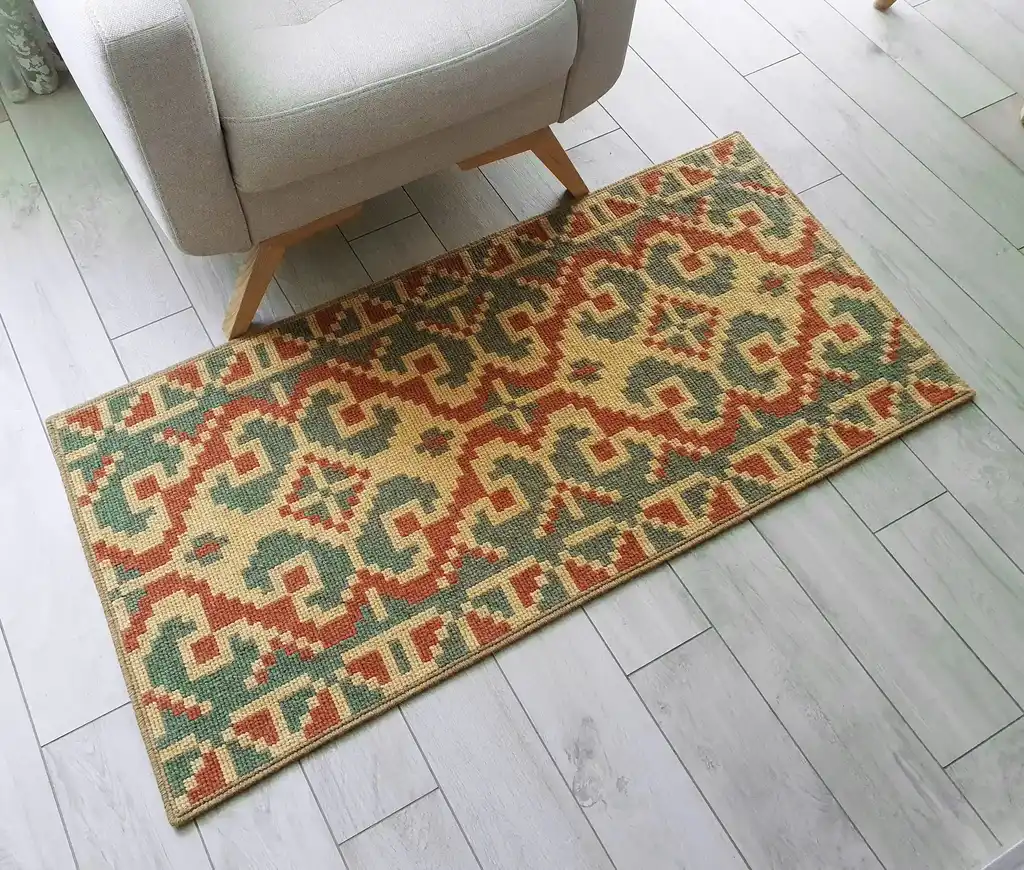 handcrafted wool rug with traditional embroidery pattern.