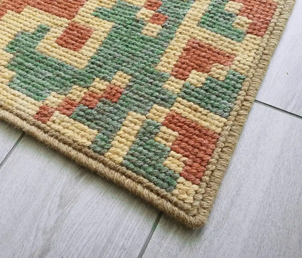 handcrafted wool rug with traditional embroidery pattern.