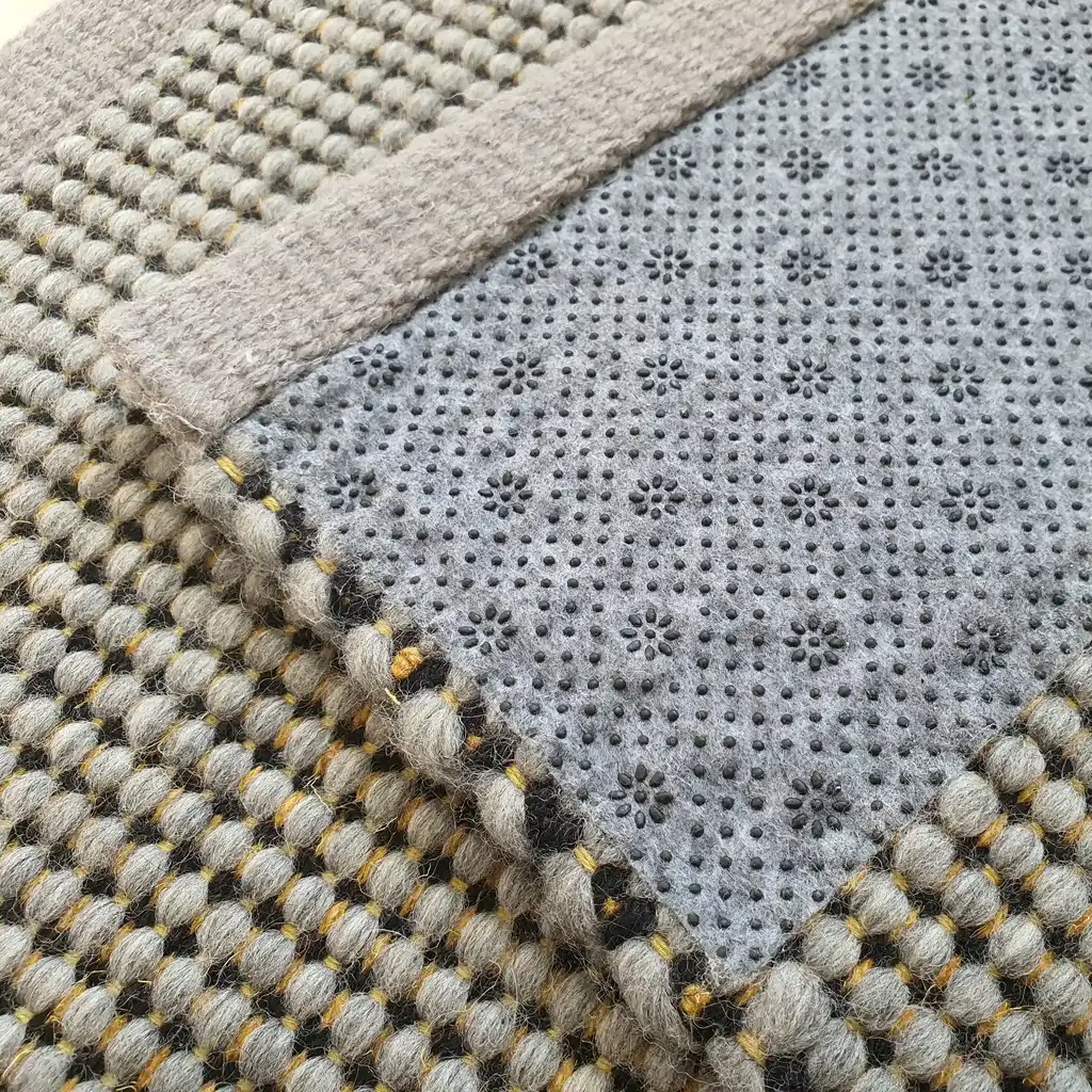 handwoven chunky wool rug with traditional weaving pattern.