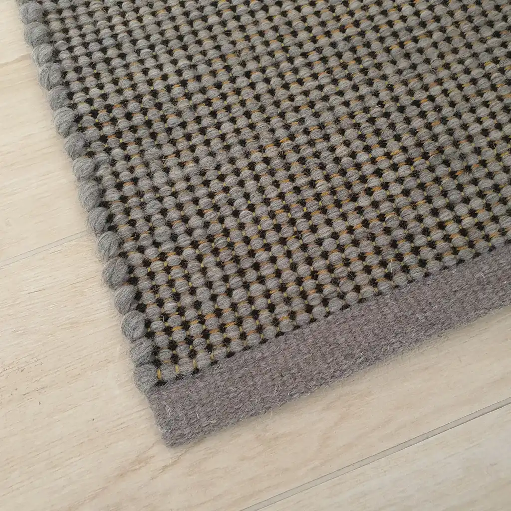 handwoven chunky wool rug with traditional weaving pattern.