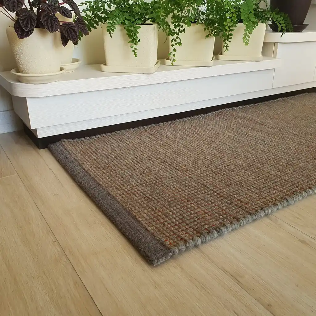 handwoven chunky wool rug in natural colors, traditional weaving technique.