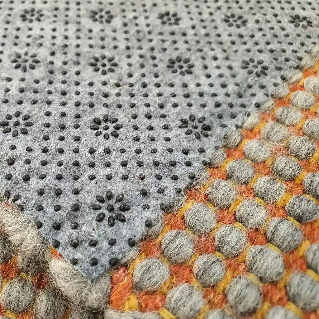 handwoven chunky wool rug in natural colors, traditional weaving technique.