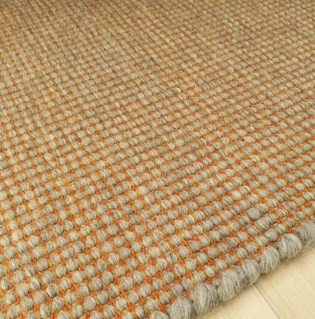 handwoven chunky wool rug in natural colors, traditional weaving technique.