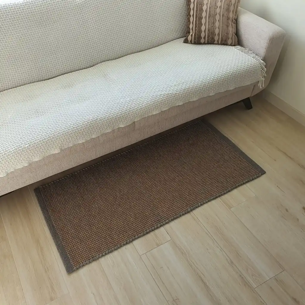 handwoven chunky wool rug in natural colors, traditional weaving technique.