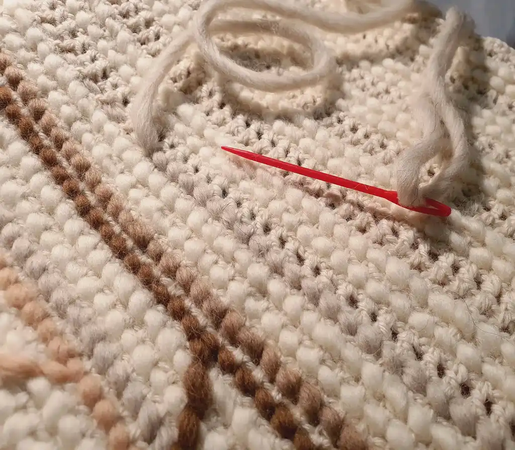 Handmade crochet blanket in merino wool with intricate patterns.
