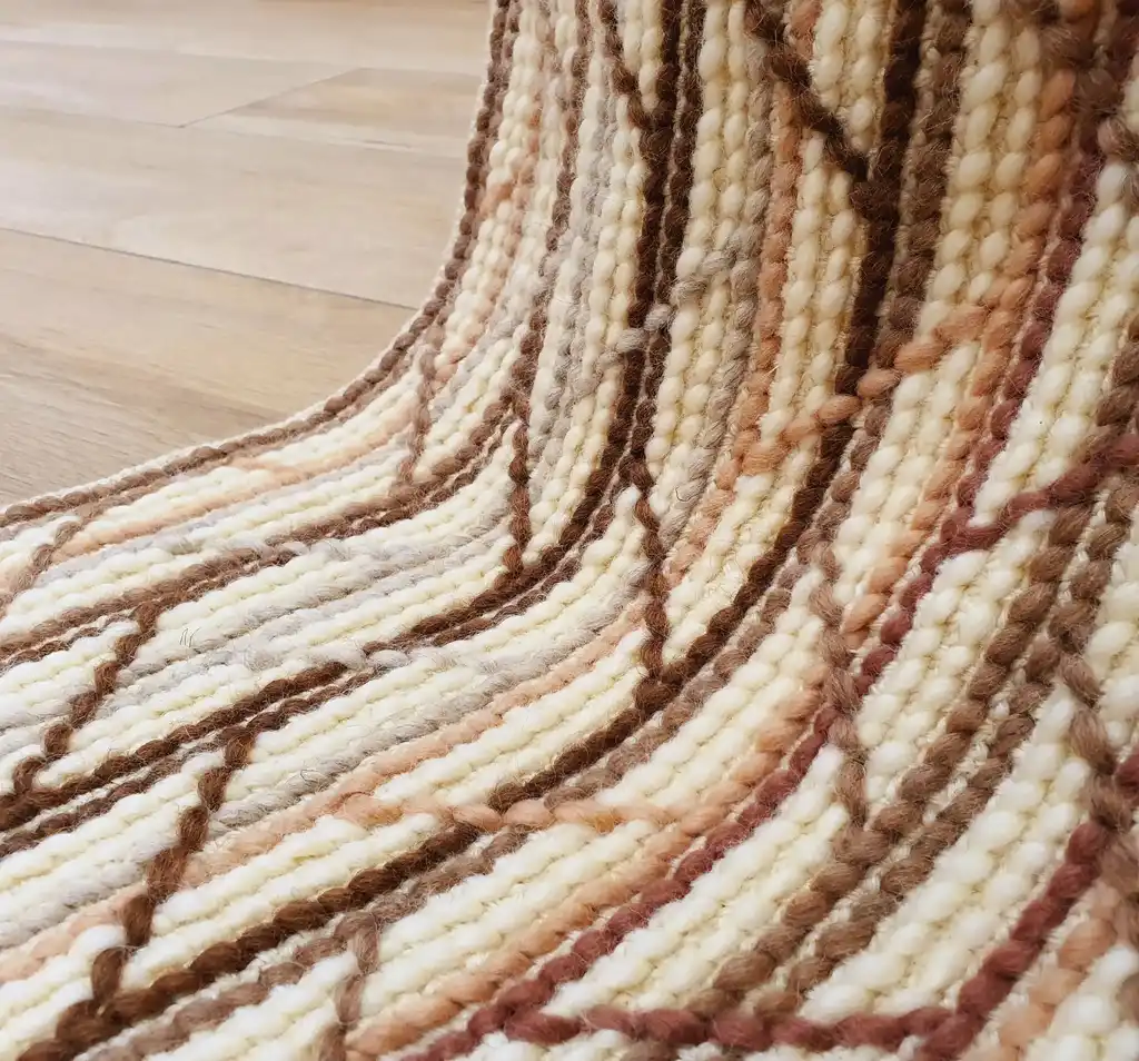 Handmade crochet blanket in merino wool with intricate patterns.