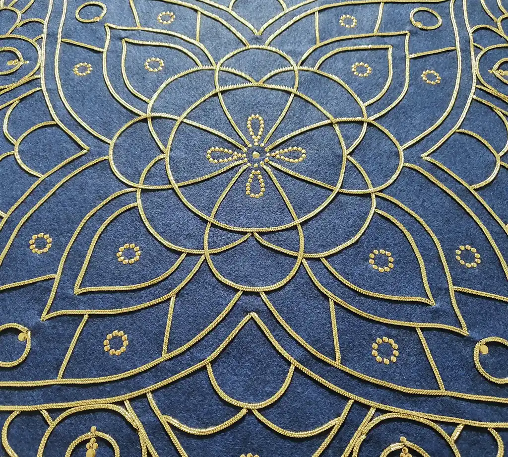 handcrafted embroidered hanging decoration with lurex cord on felt background.