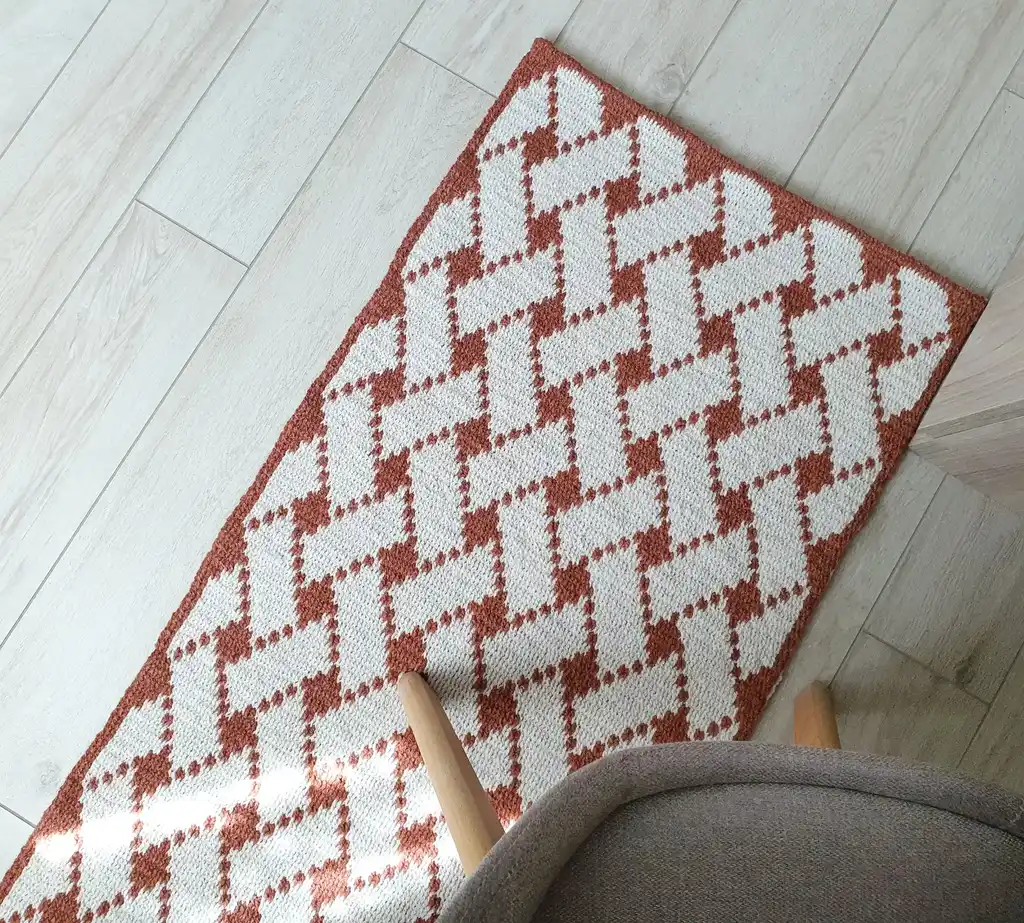 Handcrafted wool crochet rug with traditional Ukrainian Easter egg patterns in vibrant colors.