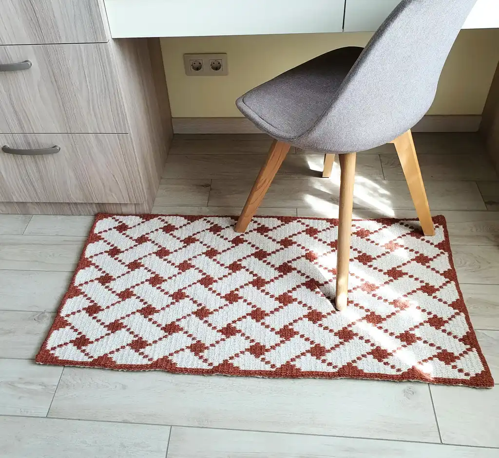 Handcrafted wool crochet rug with traditional Ukrainian Easter egg patterns in vibrant colors.