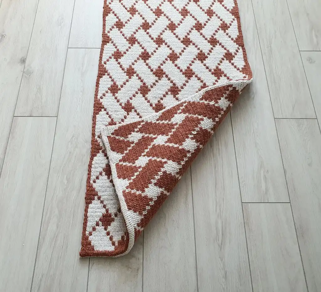 Handcrafted wool crochet rug with traditional Ukrainian Easter egg patterns in vibrant colors.