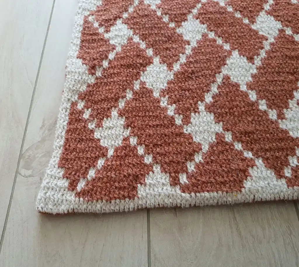 Handcrafted wool crochet rug with traditional Ukrainian Easter egg patterns in vibrant colors.