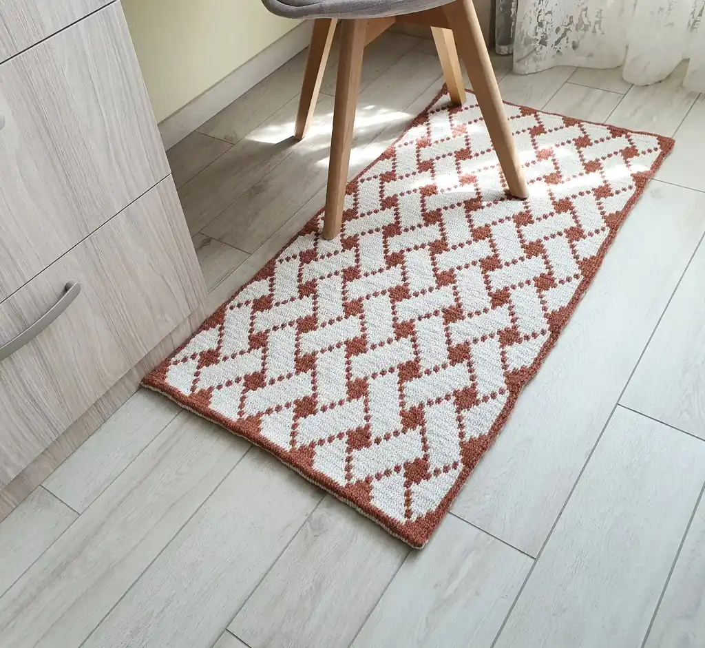 Handcrafted wool crochet rug with traditional Ukrainian Easter egg patterns in vibrant colors.