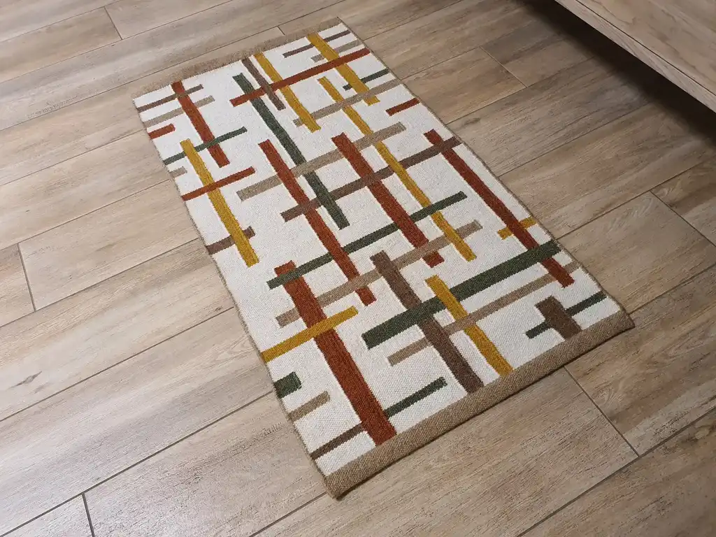 handwoven wool rug with traditional Ukrainian patterns in natural colors.