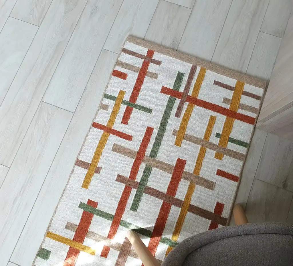 handwoven wool rug with traditional Ukrainian patterns in natural colors.
