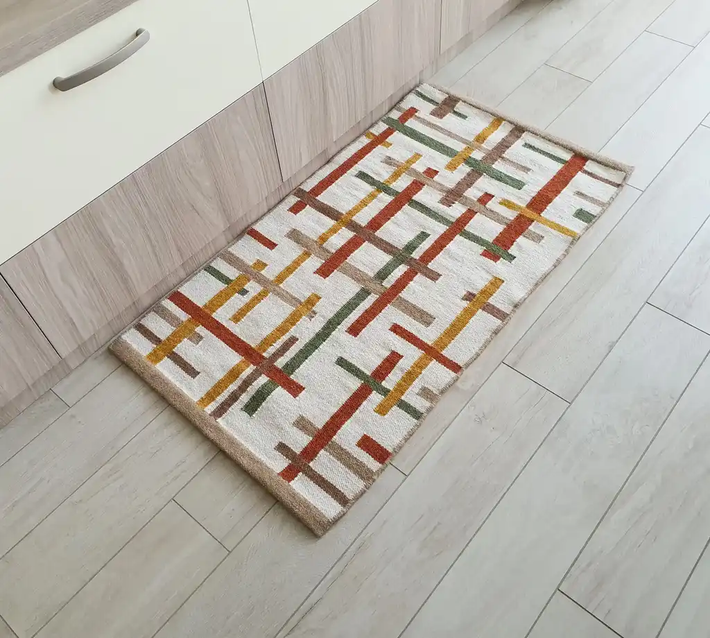 handwoven wool rug with traditional Ukrainian patterns in natural colors.