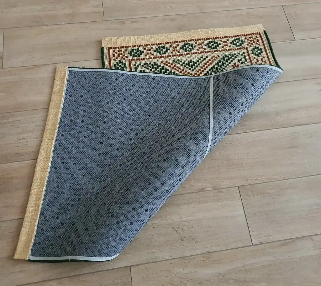 handwoven wool rug with traditional Ukrainian viburnum flower patterns in red and natural colors.