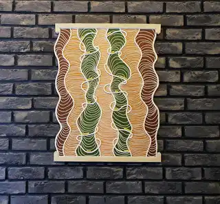 handmade embroidered wall hanging made from felt with rope and beech wood accents.