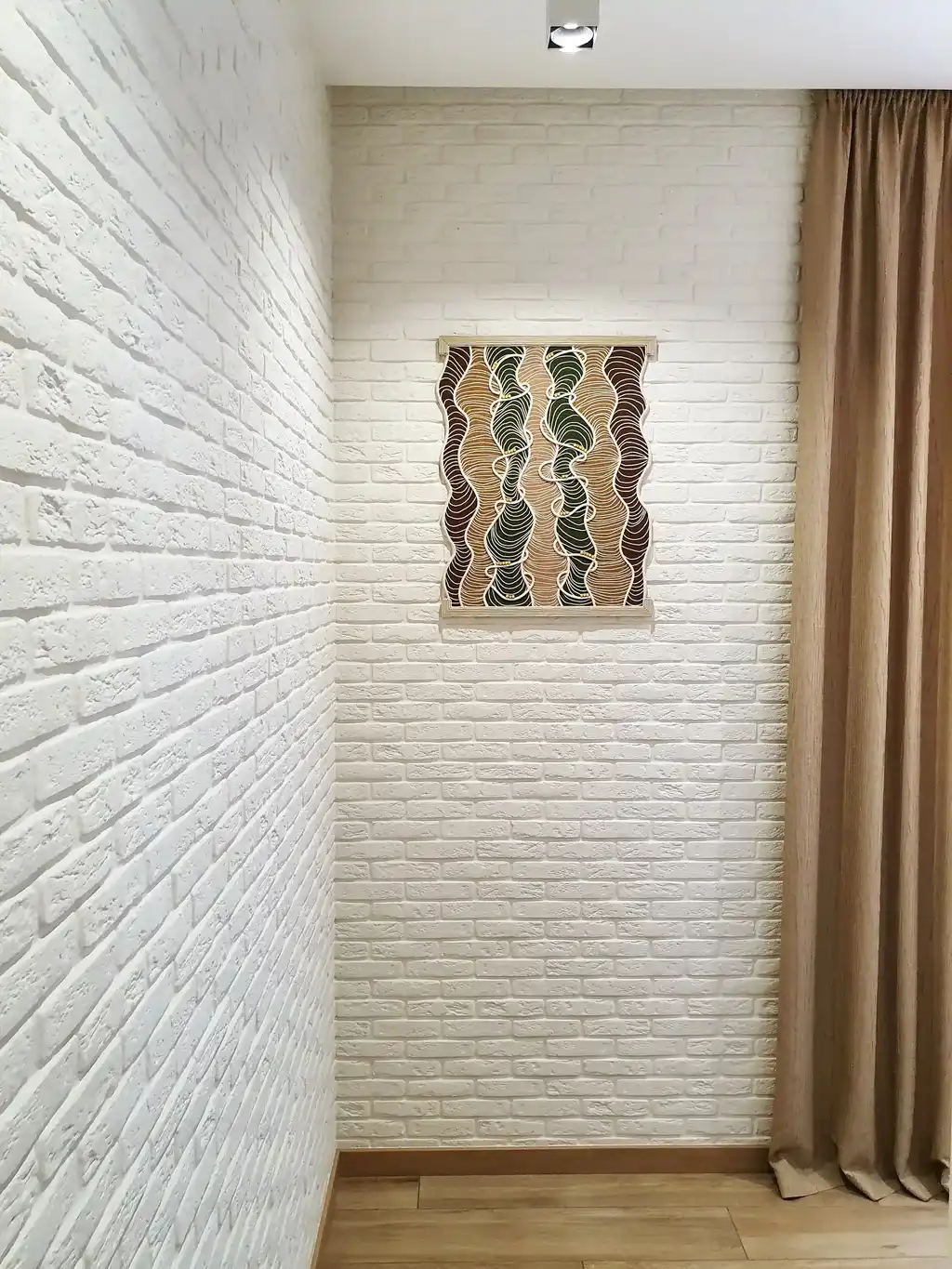 handmade embroidered wall hanging made from felt with rope and beech wood accents.