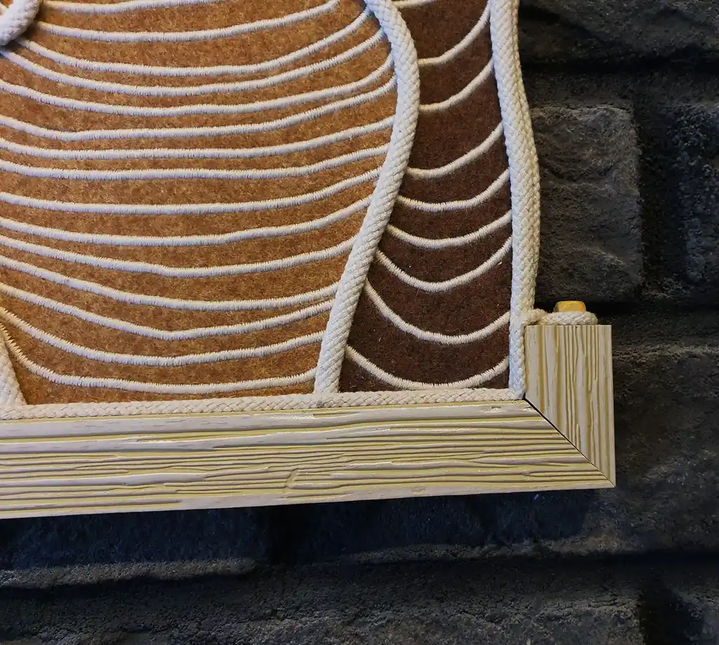 handmade embroidered wall hanging made from felt with rope and beech wood accents.