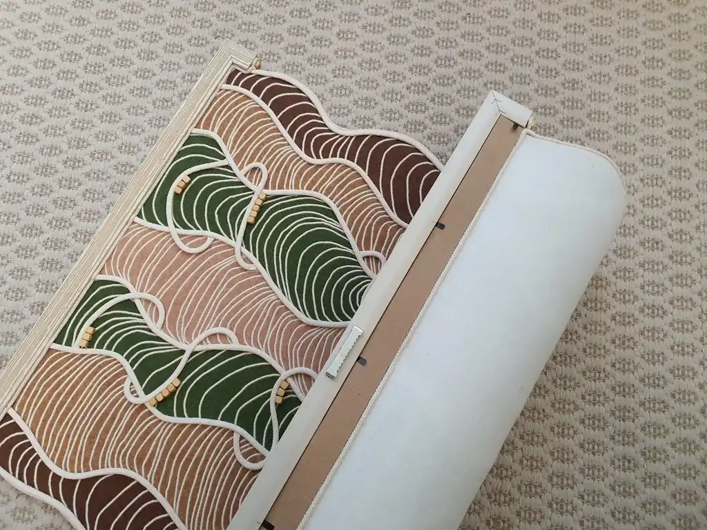 handmade embroidered wall hanging made from felt with rope and beech wood accents.