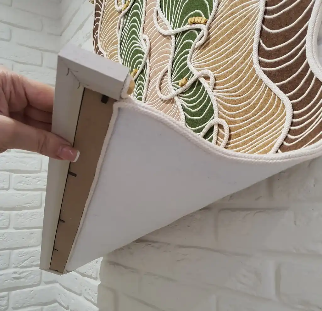 handmade embroidered wall hanging made from felt with rope and beech wood accents.