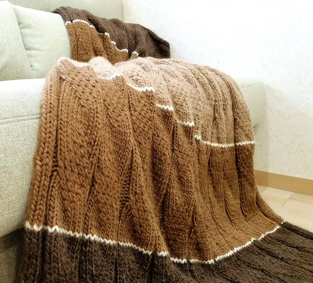 luxury knitted merino wool throw blanket in beige color.