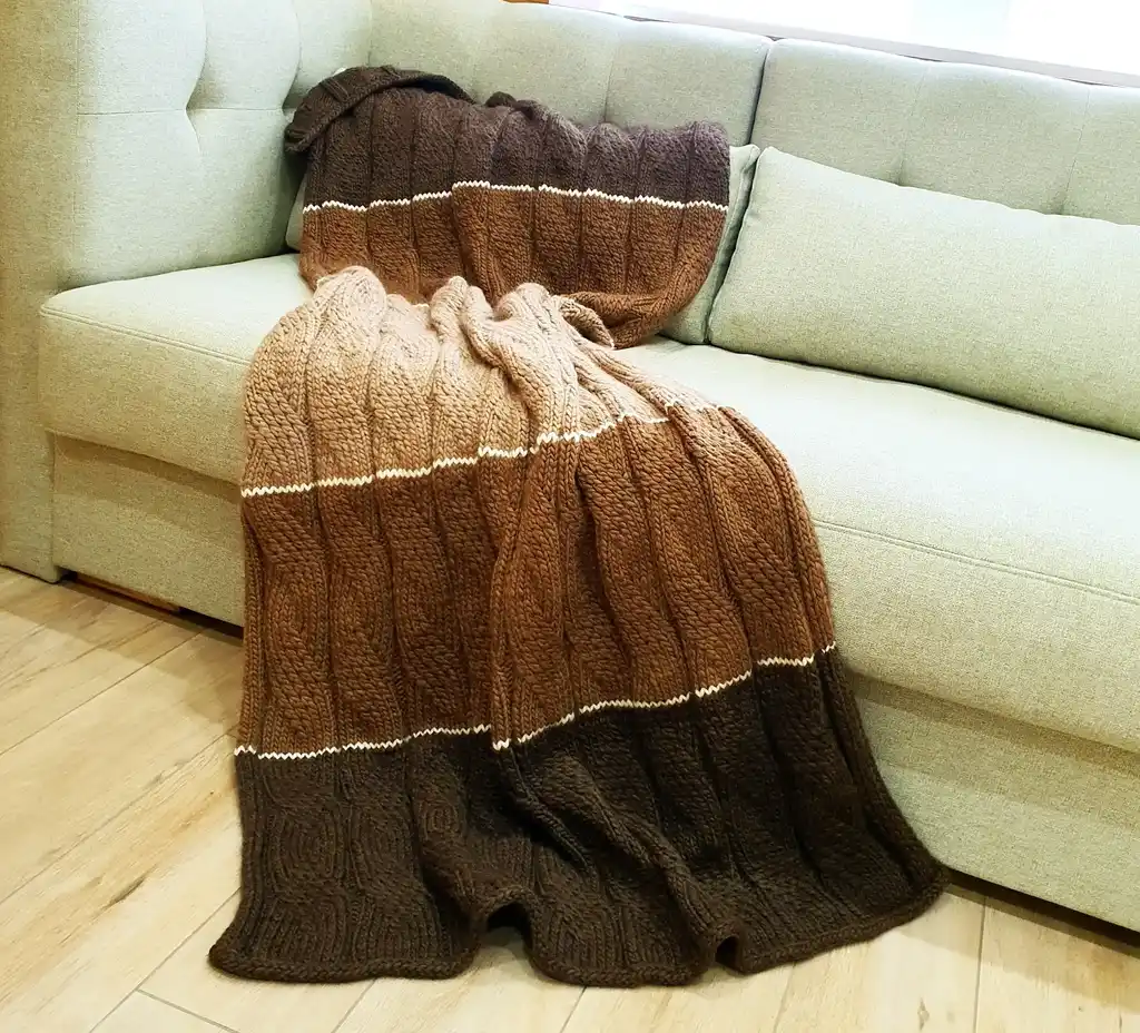luxury knitted merino wool throw blanket in beige color.