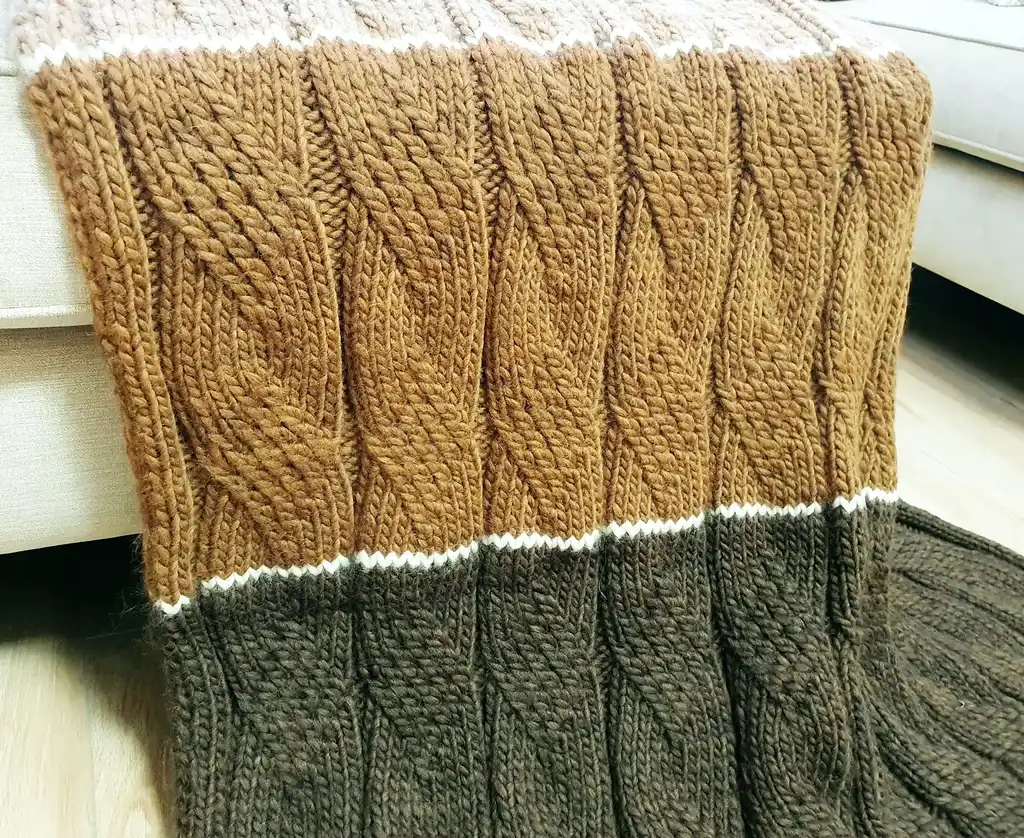 luxury knitted merino wool throw blanket in beige color.