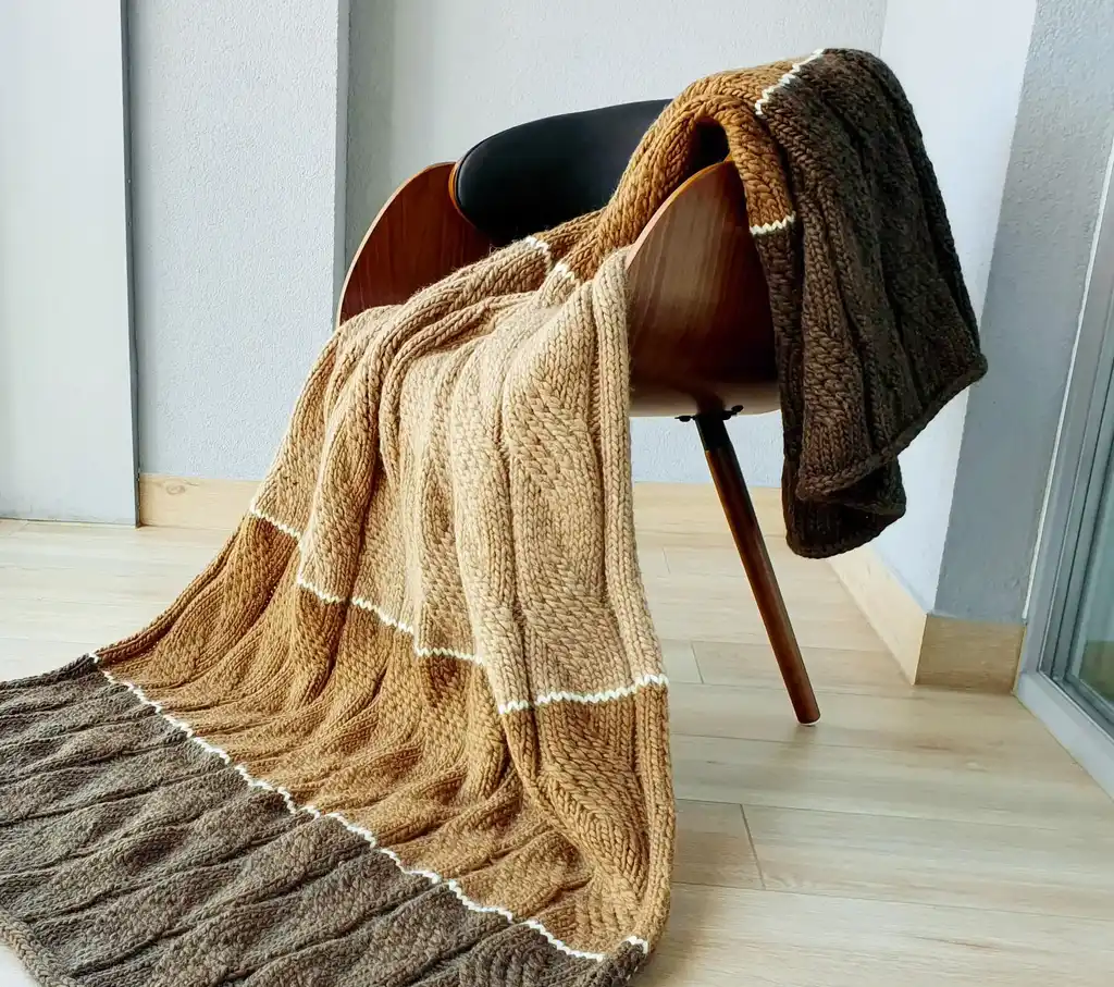 luxury knitted merino wool throw blanket in beige color.