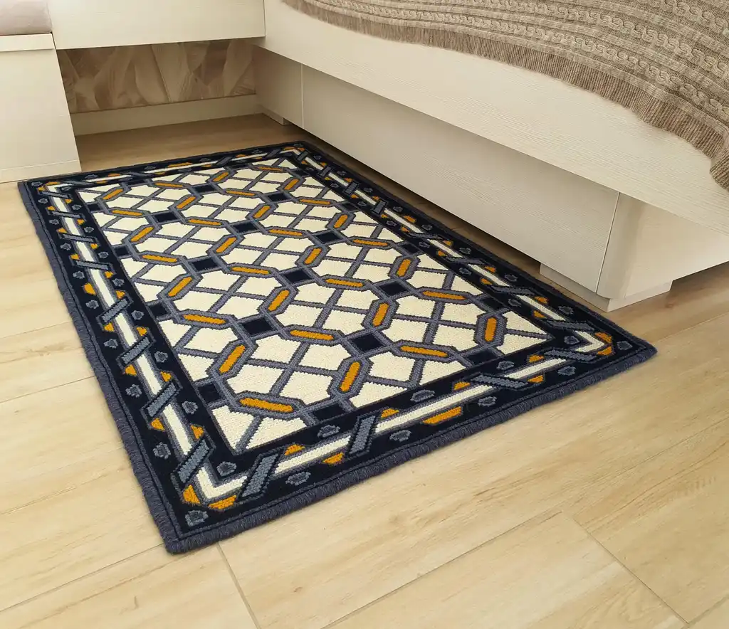 handcrafted wool rug with cross-stitch pattern.
