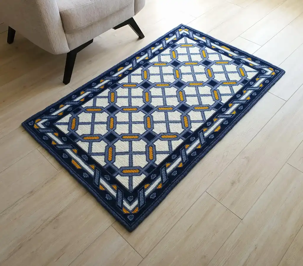 handcrafted wool rug with cross-stitch pattern.