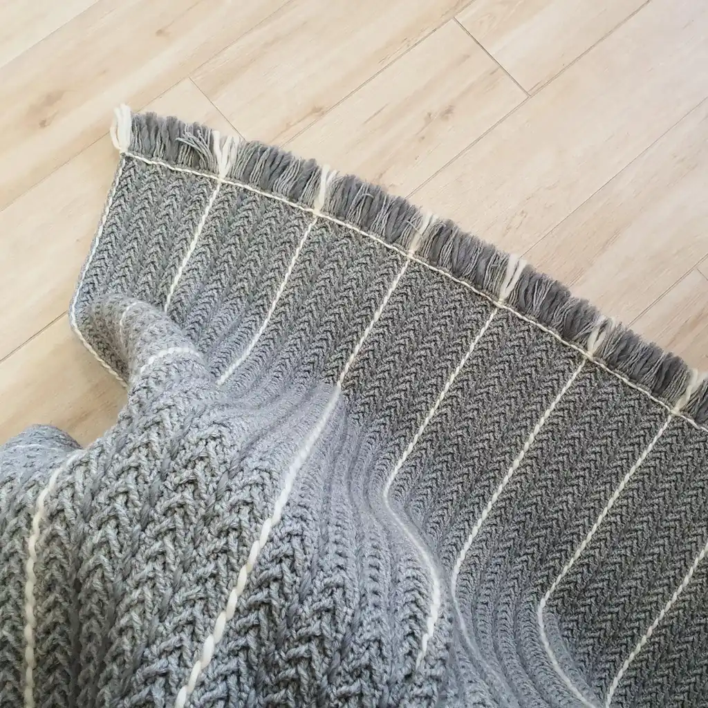 Crochet wool throw blanket in natural tones, handcrafted with traditional techniques.