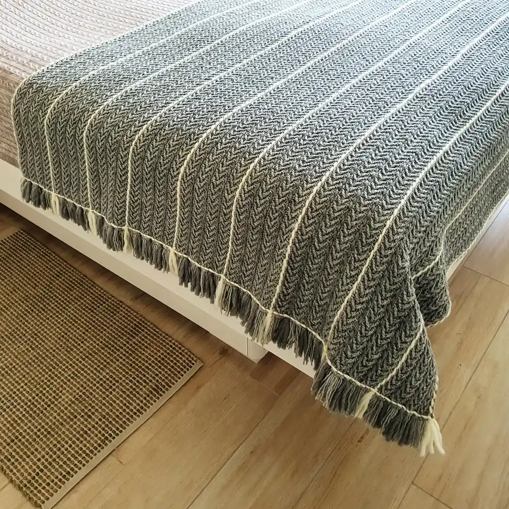 Crochet wool throw blanket in natural tones, handcrafted with traditional techniques.