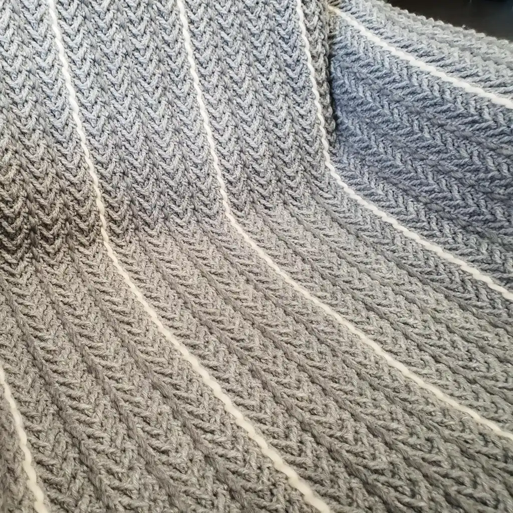 Crochet wool throw blanket in natural tones, handcrafted with traditional techniques.