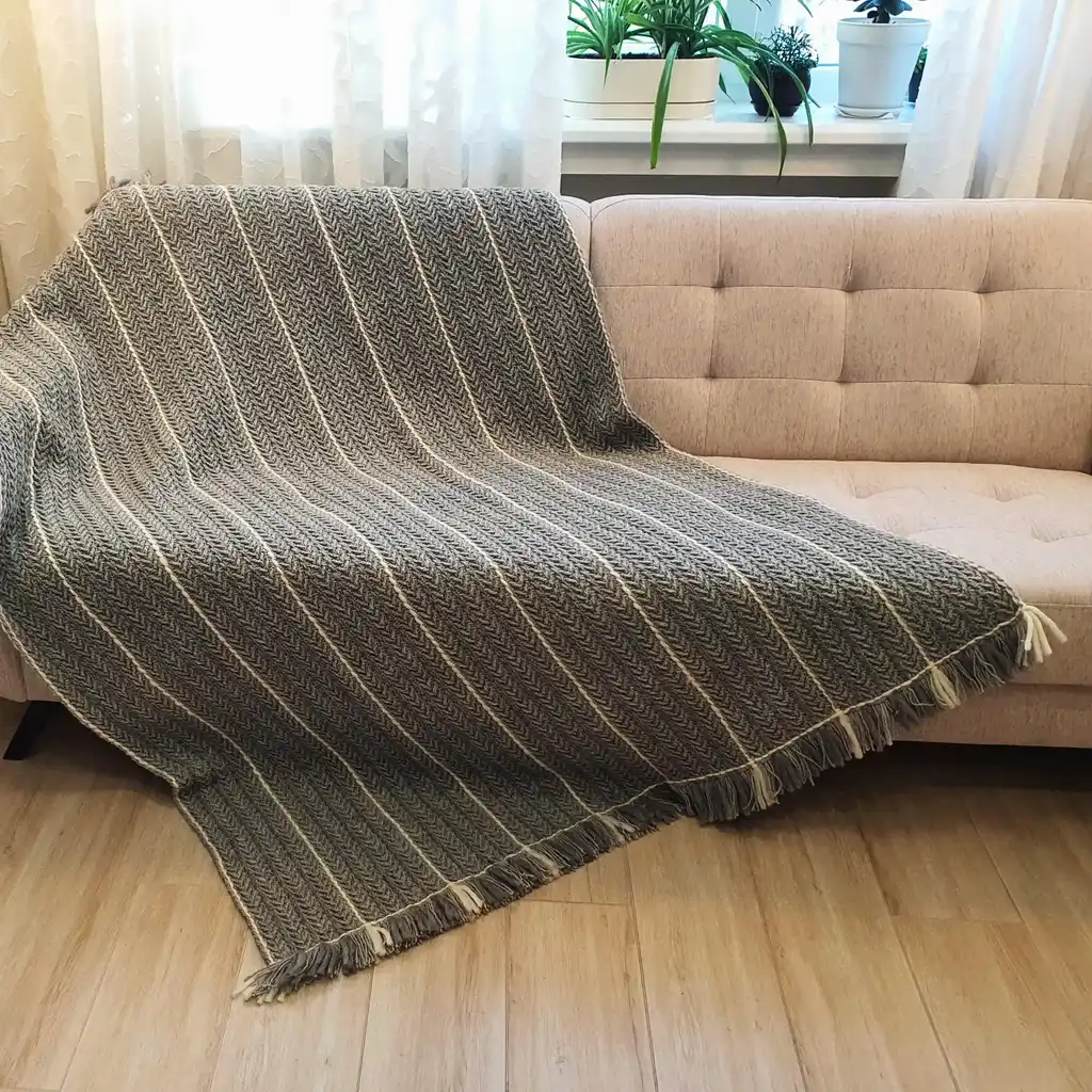 Crochet wool throw blanket in natural tones, handcrafted with traditional techniques.