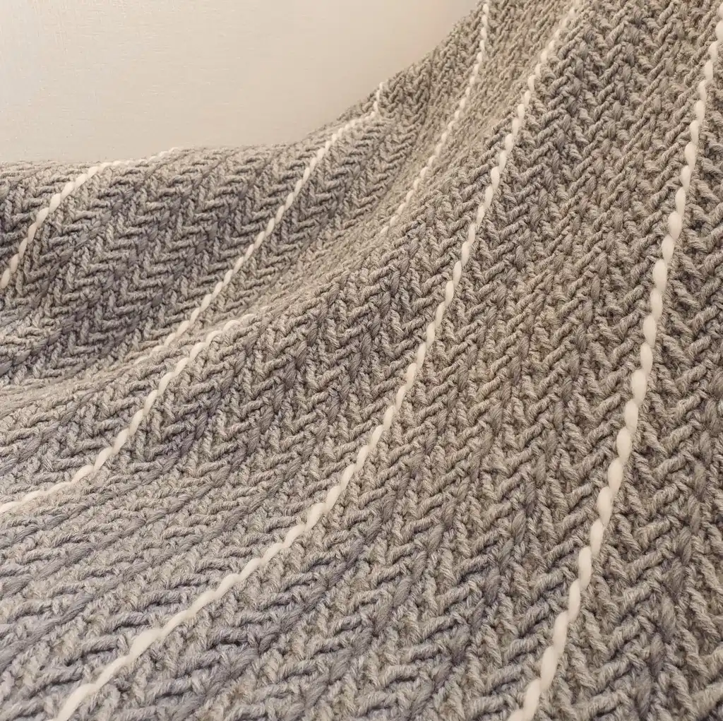 Crochet wool throw blanket in natural tones, handcrafted with traditional techniques.