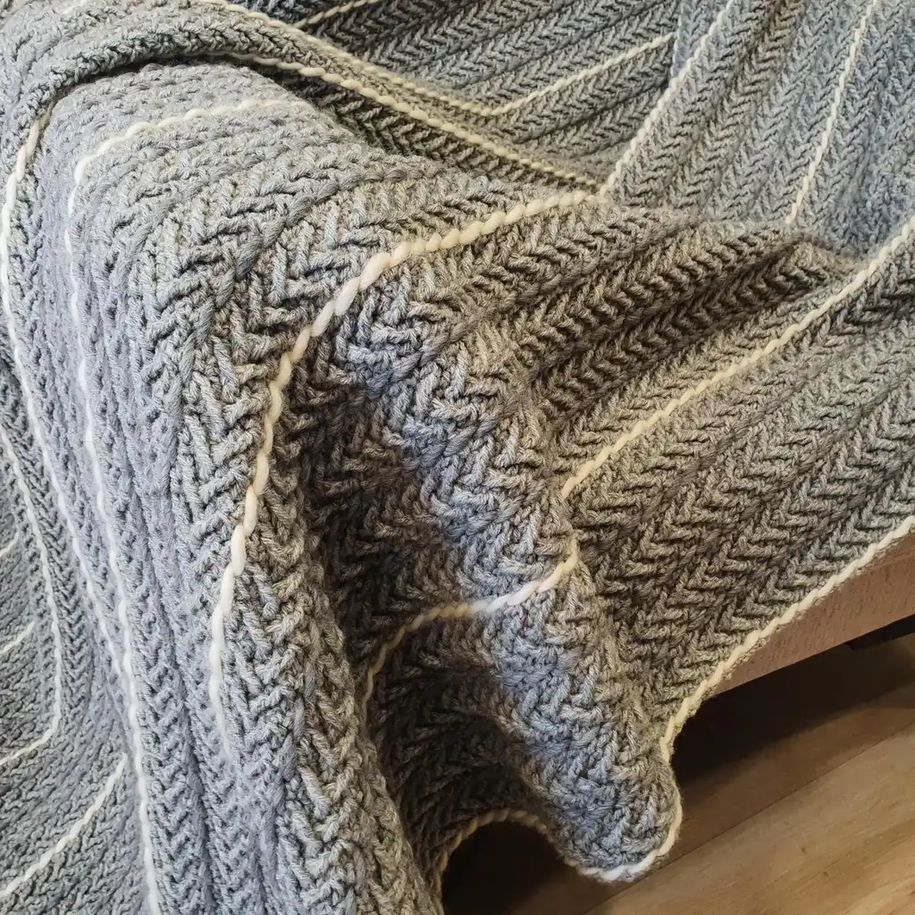 Crochet wool throw blanket in natural tones, handcrafted with traditional techniques.