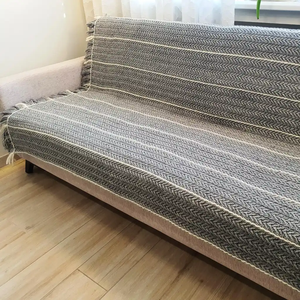 Crochet wool throw blanket in natural tones, handcrafted with traditional techniques.