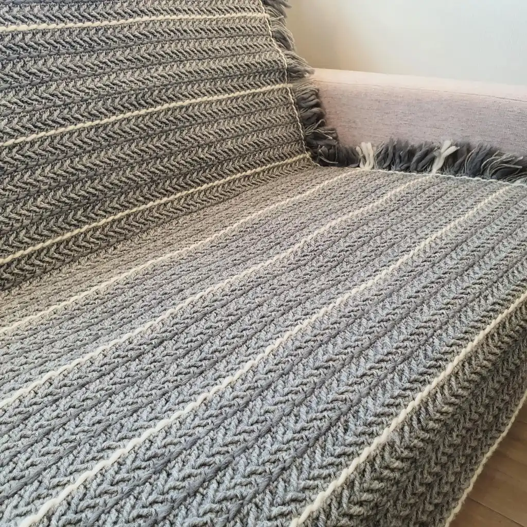 Crochet wool throw blanket in natural tones, handcrafted with traditional techniques.