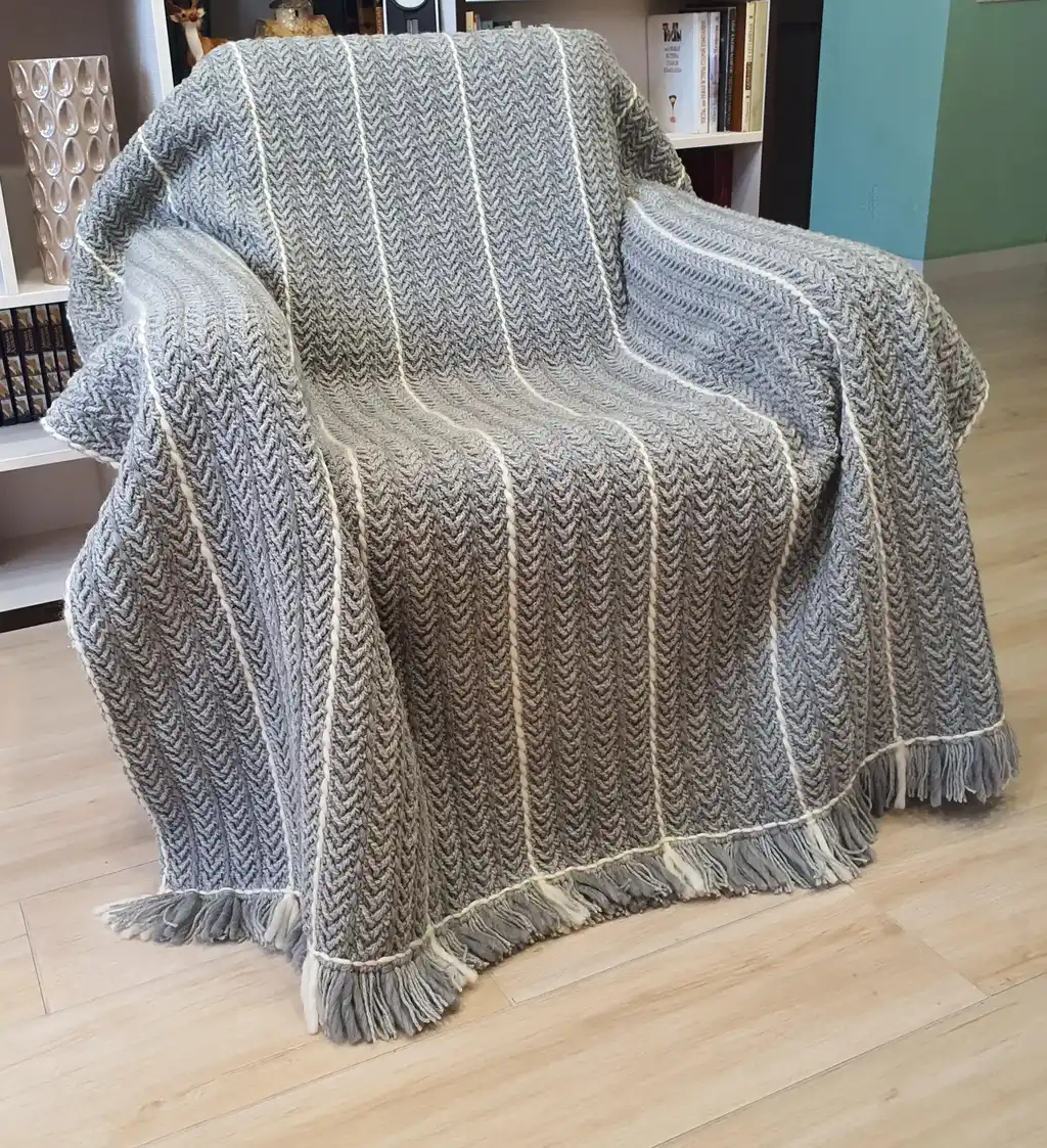 Crochet wool throw blanket in natural tones, handcrafted with traditional techniques.