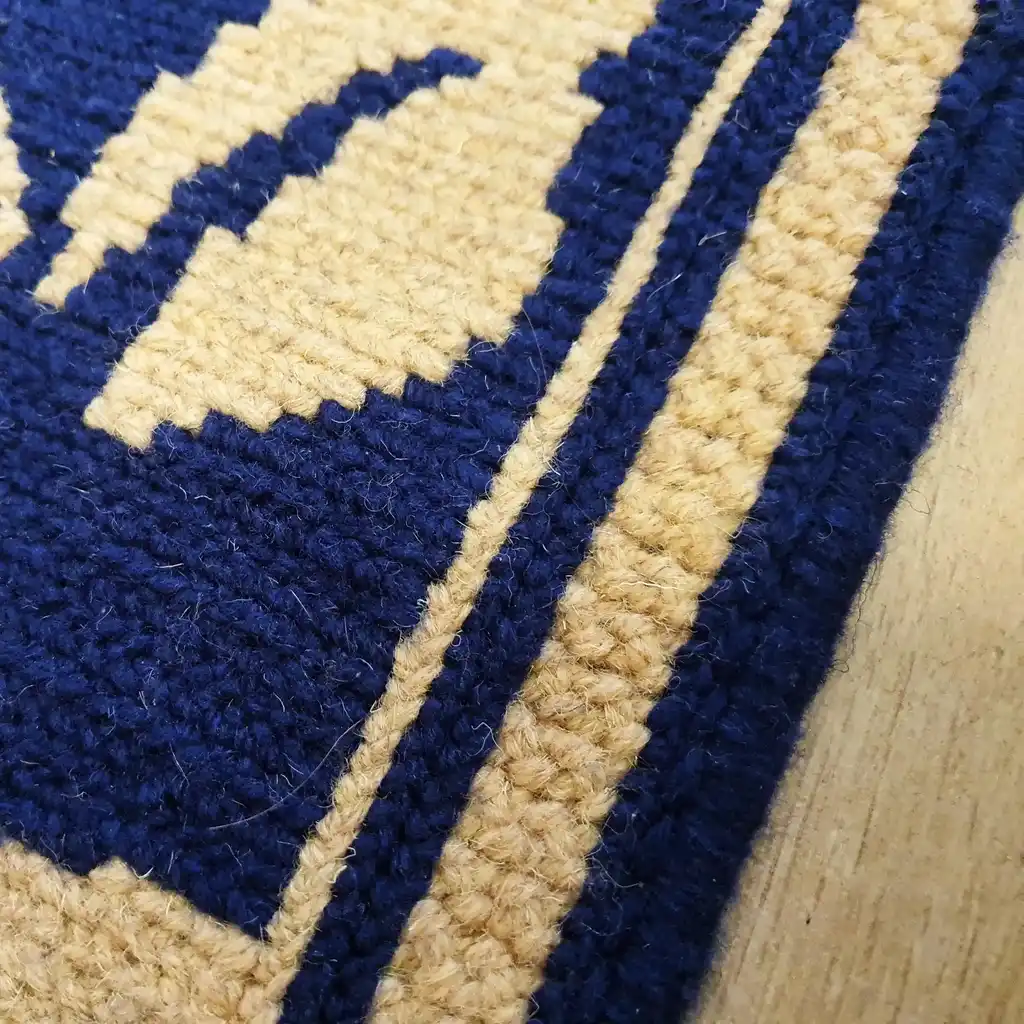 traditional Ukrainian cross-stitch wool rug with geometric patterns in earth tones.