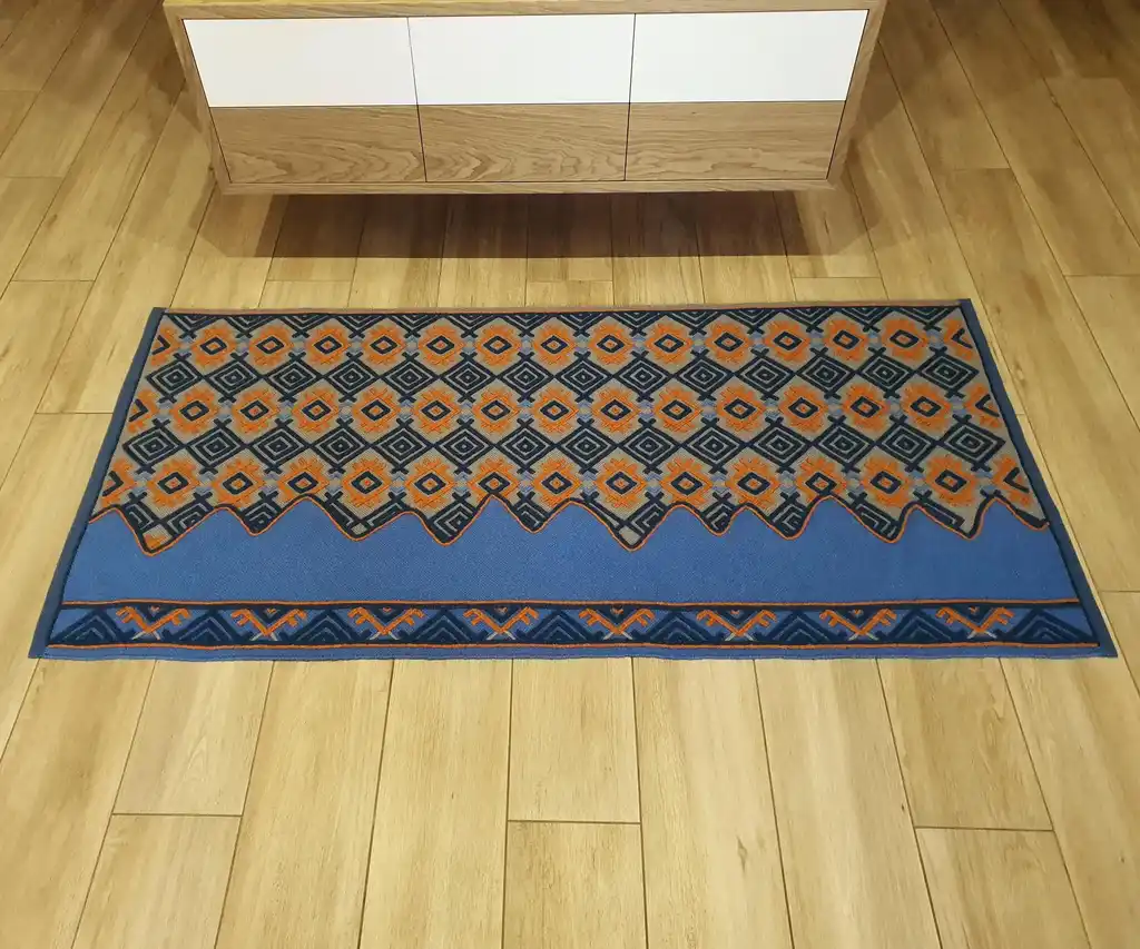 handwoven wool rug with traditional weaving pattern.