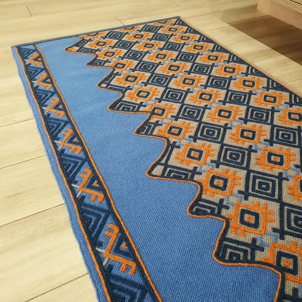 handwoven wool rug with traditional weaving pattern.