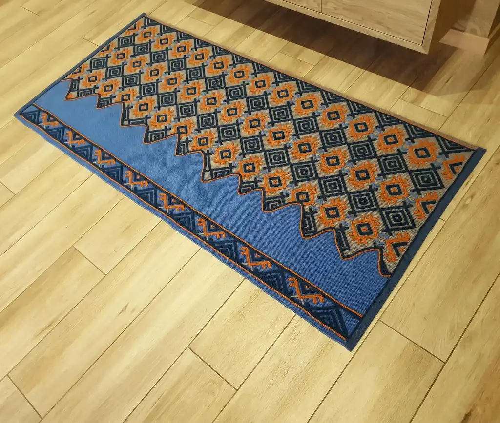 handwoven wool rug with traditional weaving pattern.
