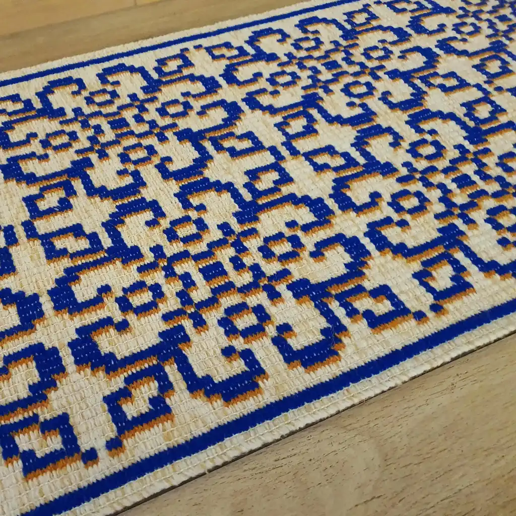 handwoven wool rug with traditional weaving pattern.