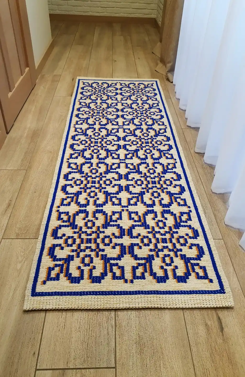 handwoven wool rug with traditional weaving pattern.