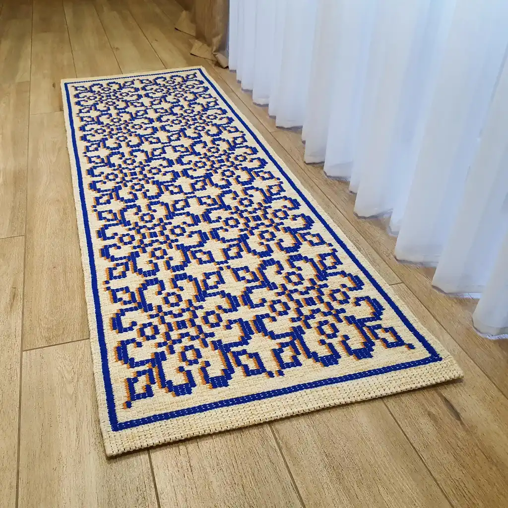 handwoven wool rug with traditional weaving pattern.