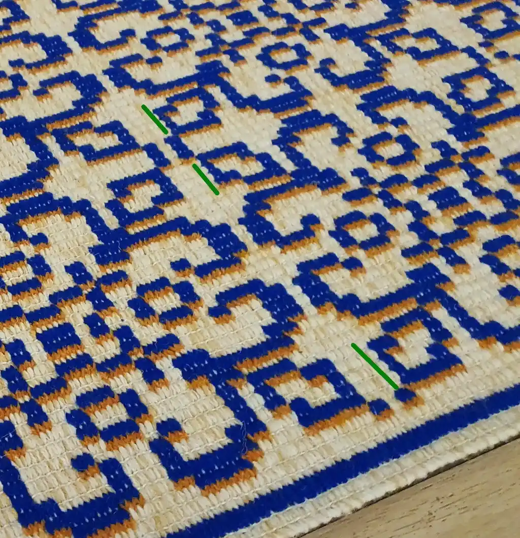 handwoven wool rug with traditional weaving pattern.