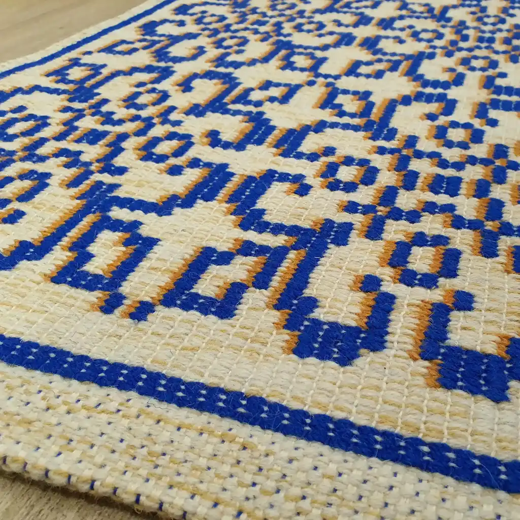 handwoven wool rug with traditional weaving pattern.